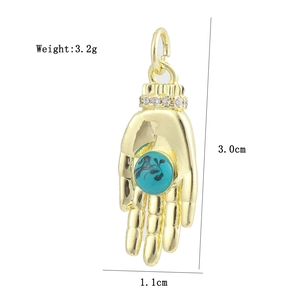 Detailed view of 18K gold plated Hamsa hand pendant with blue eye and crystal accents