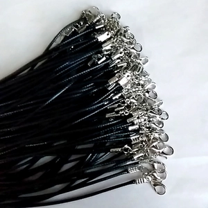 Close-up of black wax cord necklace bundles with silver-toned lobster clasps