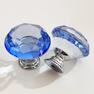 Detail of blue multifaceted crystal furniture knob with silver chrome metal base