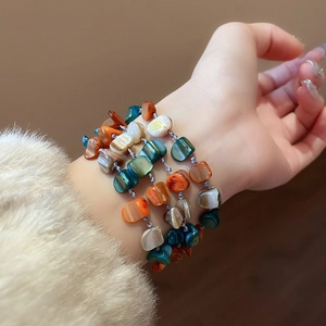 Bohemian multi-layer shell and colorful bead stacked bracelets for a trendy summer look