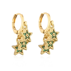 Macro shot of 18K gold plated hoop earrings with green zircon star pendants on white
