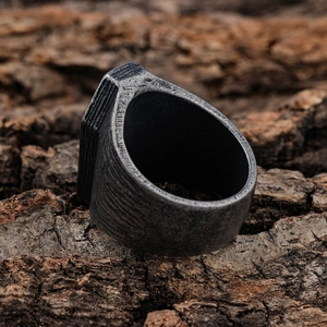 Retro punk coffin texture ring in distressed silver finish on natural tree bark background