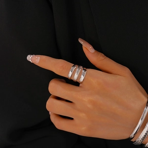 Detail of silver multi-layer open rings with smooth and textured metal finishes