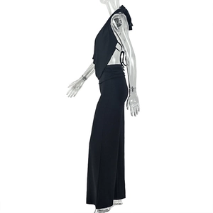 Detailed side view of black halter neck top and wide-leg trousers on a model