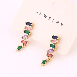 Gold dangle earrings with colorful rectangular zircons on jewelry display card