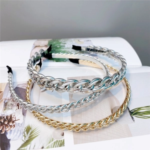 Detail shot of gold and silver metallic chain headbands on a decorative lifestyle magazine