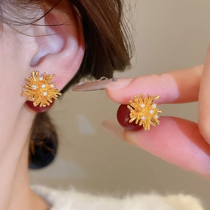 Detailed view of 18k gold plated coral earrings with red beads and zircon stones
