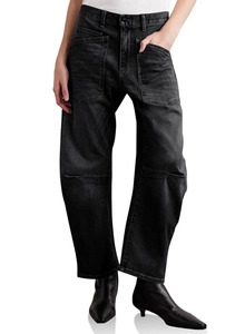 Detailed texture of black washed denim fabric on high-waist curved wide-leg trousers