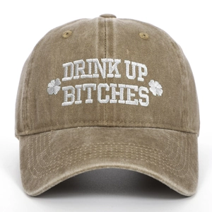 Detailed view of brown washed cotton St. Patrick's Day cap with white 'Drink Up' embroidery