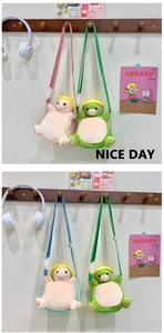 Plush animal crossbody bags in pink, green, and blue hanging on a wooden hook