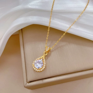 Detail of luxury teardrop pendant necklace with sparkling crystals on gold jewelry box