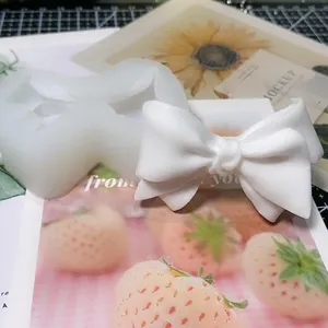 3D bow-shaped silicone mold with finished plaster ornaments for handmade aromatherapy crafts