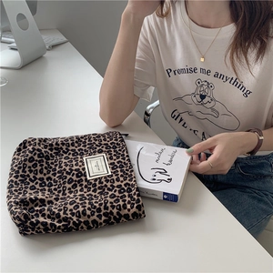 Detail of leopard print canvas pouch showing storage for books and Pleasant Time label