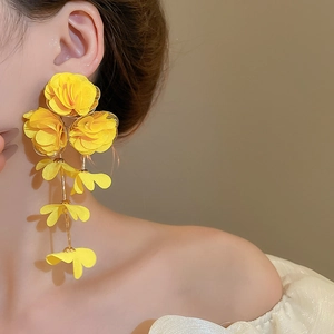 Detail of yellow fabric flower tassel earrings showing the bohemian floral design