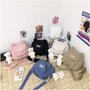 Cute canvas crossbody bags with bear ears shown in multiple colors on checkered background