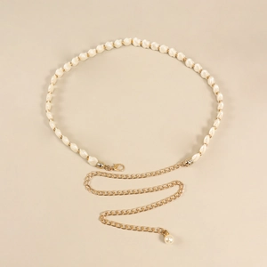 Detail view of woven leather waist chain with shell beads and pearl tassel charm