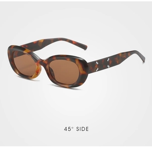 Detail view of 45-degree angle retro tortoiseshell cat-eye sunglasses with silver rivets