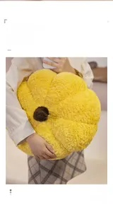 Close-up of soft yellow flower plush pillow with fuzzy texture held by a model