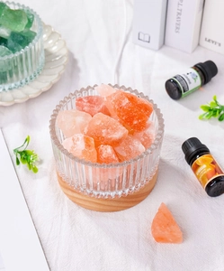 Top view of crystal aroma stones in a textured glass jar with a natural wooden base