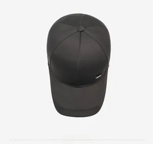 Top view of a charcoal grey baseball cap showing textured fabric and metal logo detail
