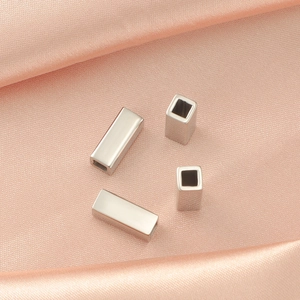 Macro detail of silver titanium steel hollow rectangular tube beads for DIY jewelry