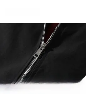Detail of a smooth silver metal zipper on premium black high-density casual fabric