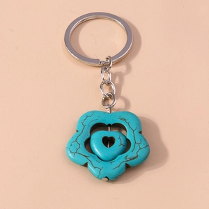 Detail of bohemian turquoise flower keychain with rotating heart and silver ring