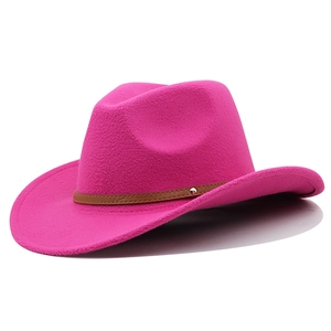 Detail of rose red wool felt cowboy hat with brown leather band and metallic stud