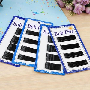 Set of black wavy metal bobby pins for hair styling on blue display cards