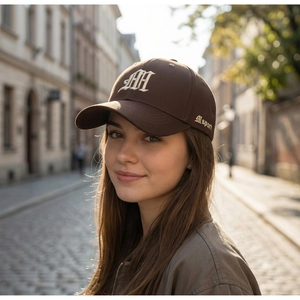 Detail of dark brown cotton baseball cap featuring white Gothic AH embroidery and M sport logo