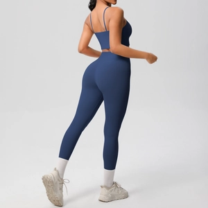 Detail of cross-back yoga top and high-waist leggings in matte navy blue fabric