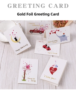 Flat lay of gold-stamped Valentine's Day greeting cards with romantic animal illustrations