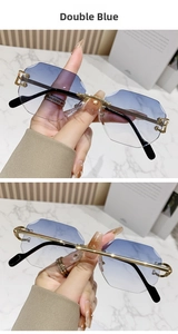 Detail view of rimless octagon sunglasses with blue gradient lenses and gold metal temples