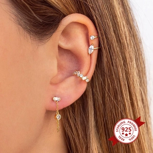 Gold s925 silver fringe earrings with round zircon stones shown on a model