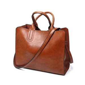 Brown vintage PU leather tote bag with dual handles and long shoulder strap detail