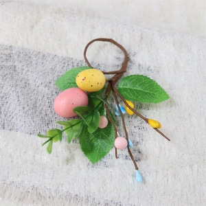 Detail of Easter napkin ring with speckled eggs, eucalyptus leaves and berries