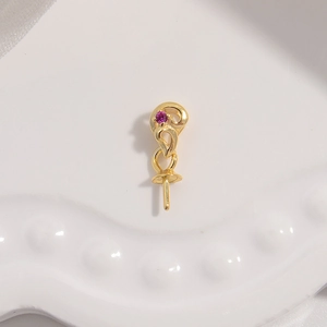 Macro detail of a gold S925 silver pendant setting with pink gemstone for pearl DIY jewelry