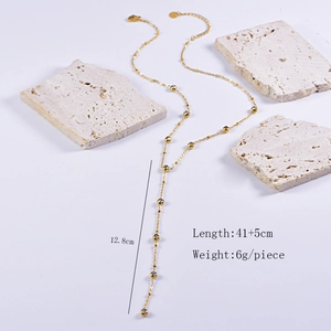 Detail of gold Y-shaped necklace with small beads and clear stones showing size 41+5cm
