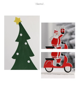 Detail of wooden Santa on red scooter and green Christmas tree tabletop decoration set