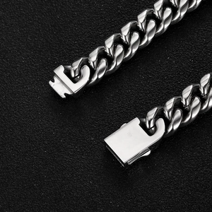 Macro shot of silver Cuban link chain with detailed U-shaped mechanical metal clasp