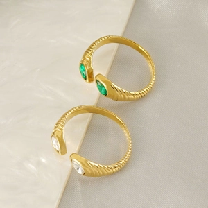 Detailed close-up of 18K gold-plated teardrop zircon snake rings with spiral texture design