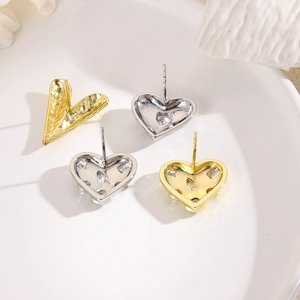 Minimalist gold and silver heart stud earrings with sparkling cubic zirconia inlay