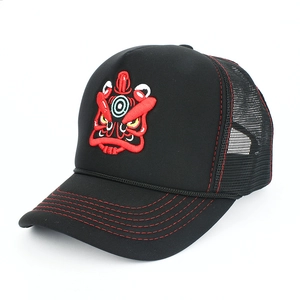 Detail view of black trucker hat with red mask embroidery and contrast stitching