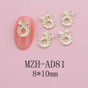 Detailed 8x10mm golden butterfly bow nail art charms with intricate alloy hollow design
