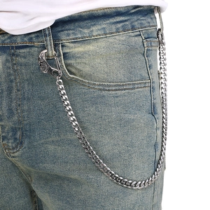 Close-up of silver steel cuban link pants chain with moon face clasp on blue jeans