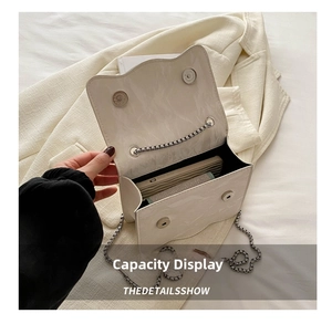Detail view of the mini marble pattern chain bag showing interior storage capacity
