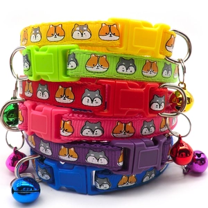 Detailed stack of six colorful pet collars with festive snowflake prints and metal bells