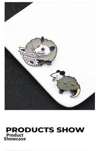 Detail view of zinc alloy enamel opossum pins with Awesome Possum banner on white stand