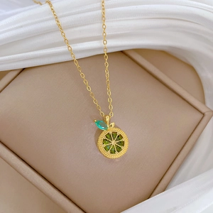 Elegant gold titanium steel necklace featuring a sparkling green lemon slice pendant