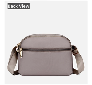 Rear view of taupe nylon crossbody bag featuring back zipper pocket and gold hardware